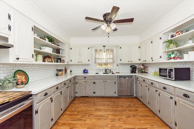 kitchen with gray cabinets, sink, light hardwood / wood-style floors, and stainless steel appliances