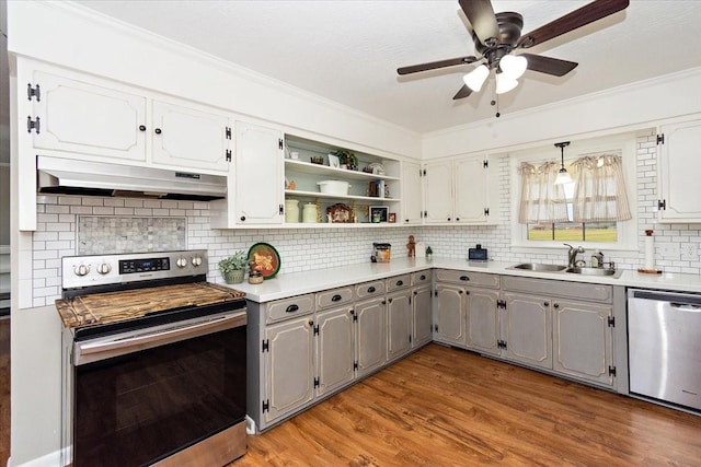 kitchen with appliances with stainless steel finishes, gray cabinetry, sink, white cabinets, and light hardwood / wood-style floors