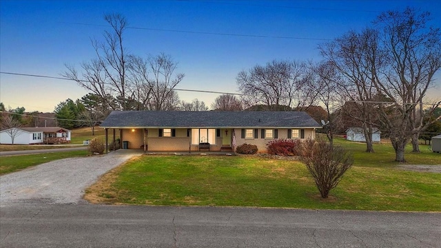 single story home with a yard and a carport