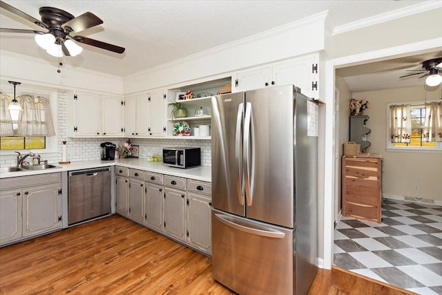 kitchen with gray cabinetry, sink, white cabinets, and stainless steel appliances