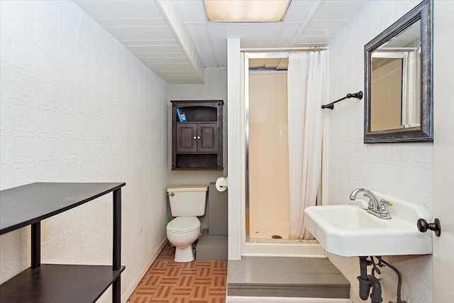 bathroom featuring parquet flooring, a shower with curtain, and toilet