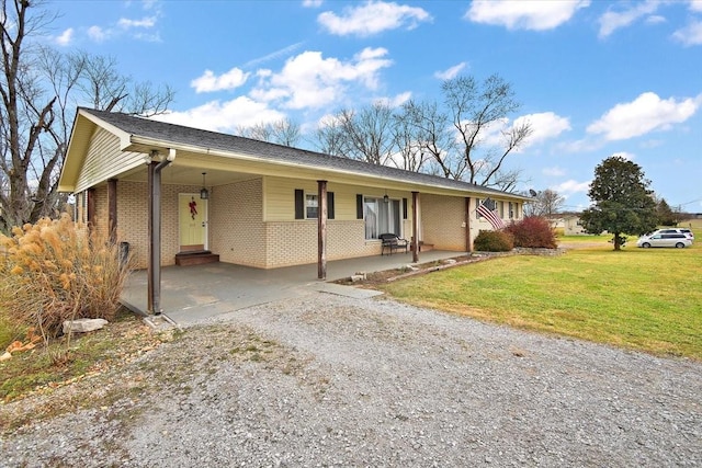 ranch-style house featuring a carport and a front lawn