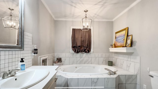 bathroom with tiled tub, crown molding, vanity, and toilet