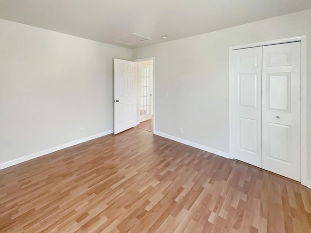 unfurnished bedroom featuring a closet and hardwood / wood-style floors