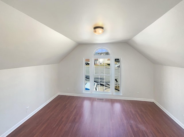 bonus room featuring lofted ceiling and dark wood-type flooring