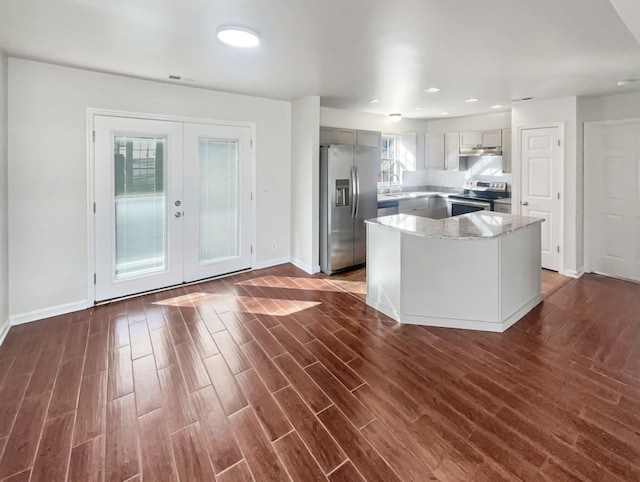 kitchen featuring a center island, french doors, sink, appliances with stainless steel finishes, and dark hardwood / wood-style flooring