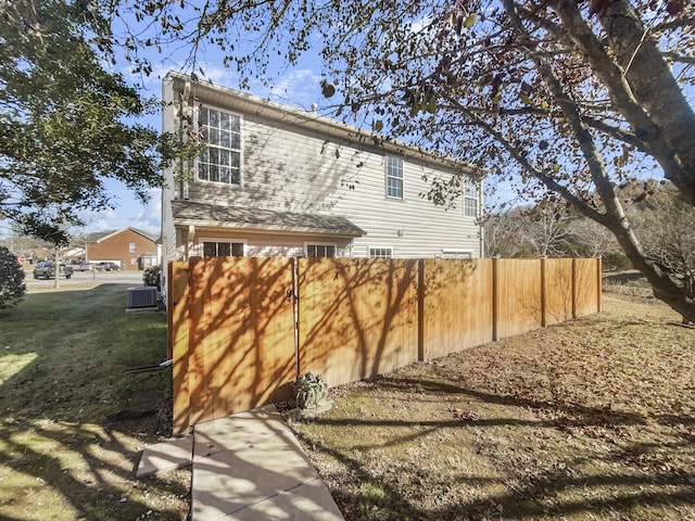 rear view of property featuring central air condition unit