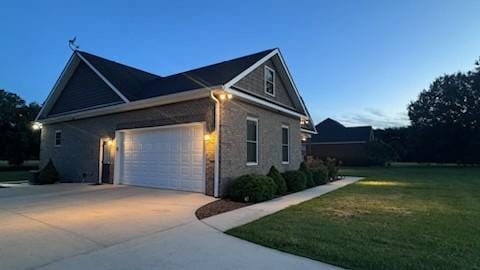 property exterior at dusk with a lawn