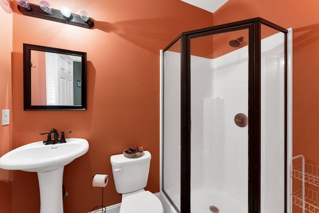 bathroom with toilet and walk in shower