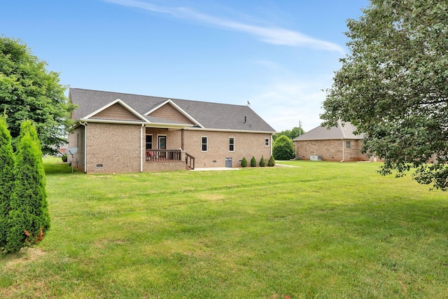 rear view of house featuring a lawn