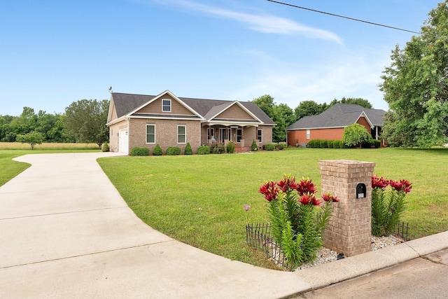 craftsman-style house with a front yard, a garage, and covered porch