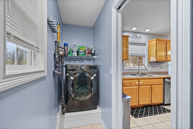 laundry area featuring washer / dryer, light tile patterned floors, and sink