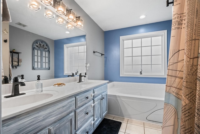 bathroom featuring a bathtub, vanity, a chandelier, and tile patterned flooring