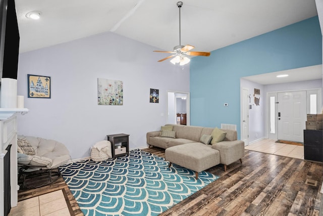 living room with light hardwood / wood-style flooring, ceiling fan, and lofted ceiling