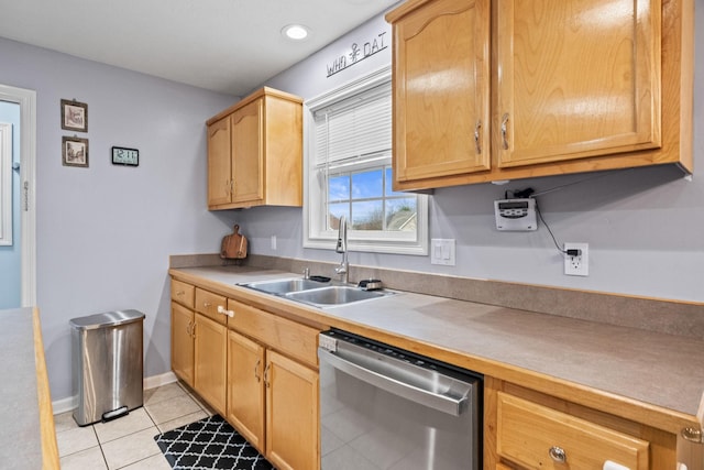 kitchen featuring stainless steel dishwasher, light tile patterned flooring, and sink