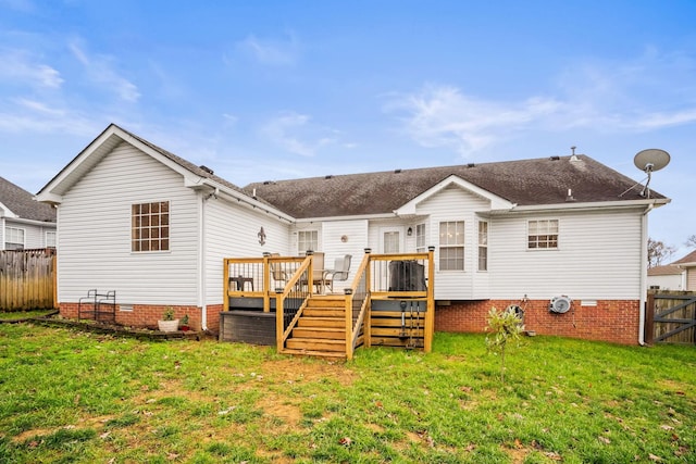 back of property with a lawn and a wooden deck