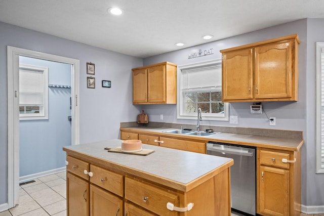 kitchen featuring dishwasher, a kitchen island, light tile patterned floors, and sink