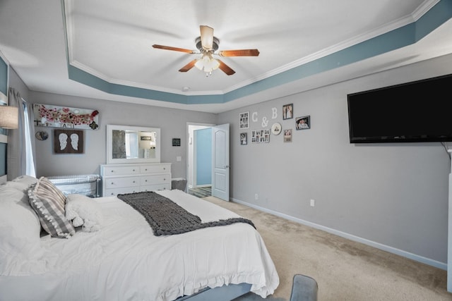 carpeted bedroom with a raised ceiling, ceiling fan, and crown molding