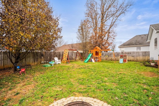 view of yard with a playground and an outdoor fire pit