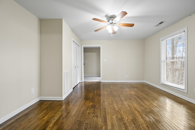 unfurnished room featuring ceiling fan and dark hardwood / wood-style flooring