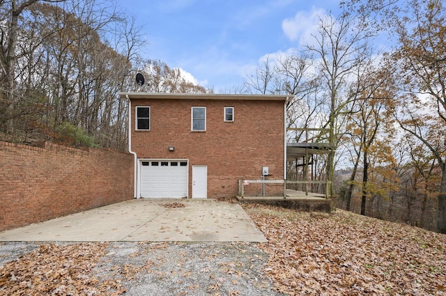 rear view of property featuring a garage