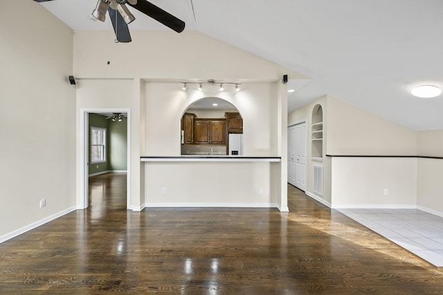 unfurnished living room with hardwood / wood-style floors, ceiling fan, and lofted ceiling