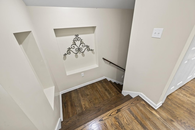 stairs with hardwood / wood-style flooring