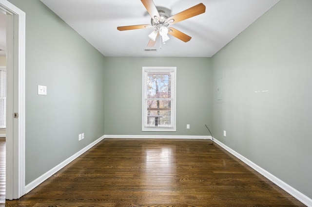 empty room with ceiling fan and dark wood-type flooring