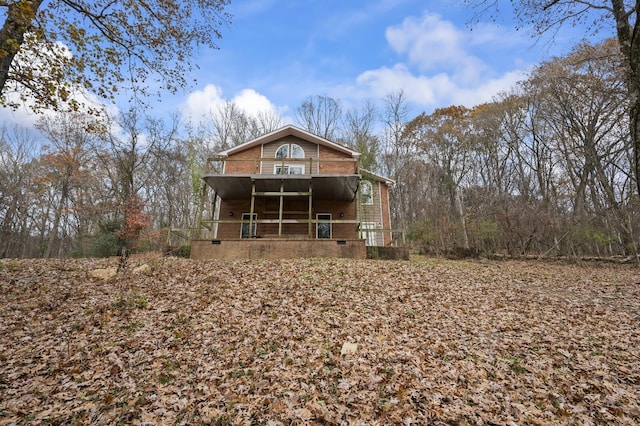 back of house featuring a balcony