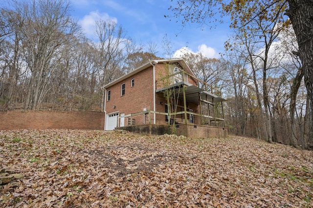 view of property exterior featuring covered porch, a garage, and a balcony