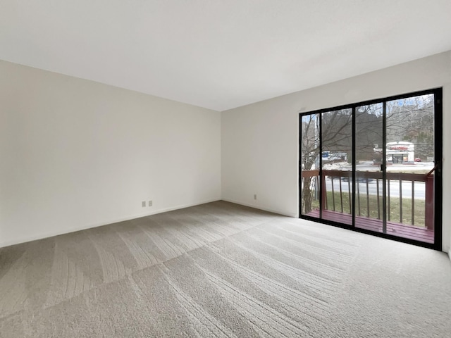 carpeted spare room featuring a healthy amount of sunlight