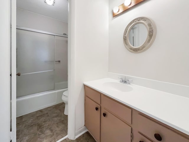 full bathroom featuring combined bath / shower with glass door, vanity, and toilet