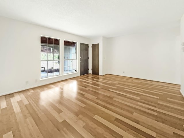 spare room with hardwood / wood-style flooring and a textured ceiling