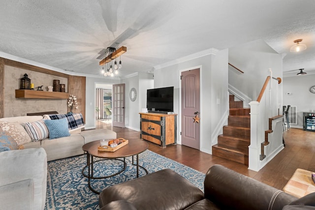 living room with a textured ceiling, crown molding, and dark wood-type flooring