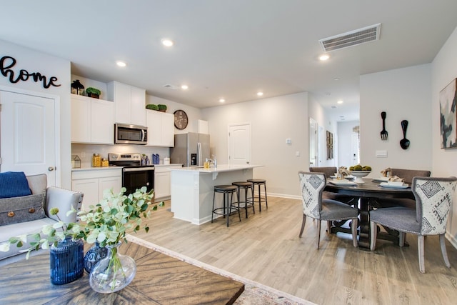 dining space featuring light hardwood / wood-style flooring