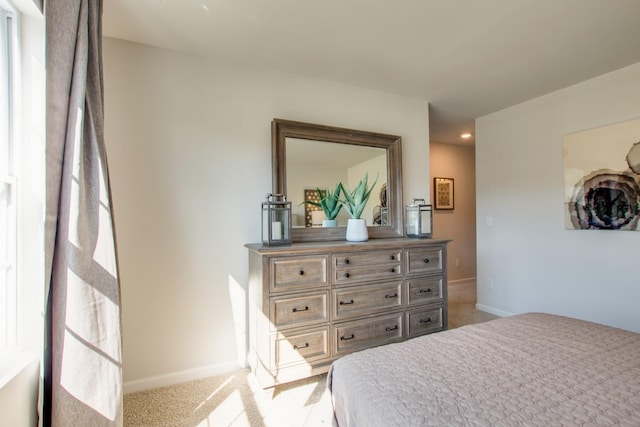 bedroom with light carpet and multiple windows