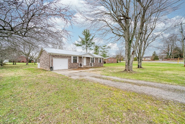 single story home with a garage and a front lawn