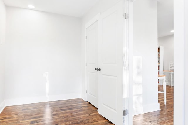 corridor with dark hardwood / wood-style floors