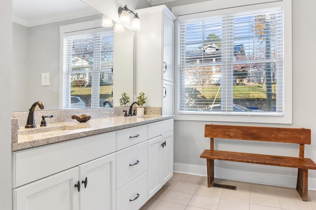 bathroom featuring tile patterned floors, crown molding, and vanity