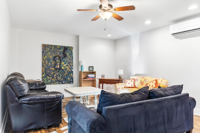 living room featuring light hardwood / wood-style floors, a wall mounted AC, and ceiling fan