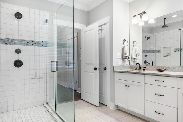 bathroom featuring crown molding, tile patterned flooring, vanity, and an enclosed shower