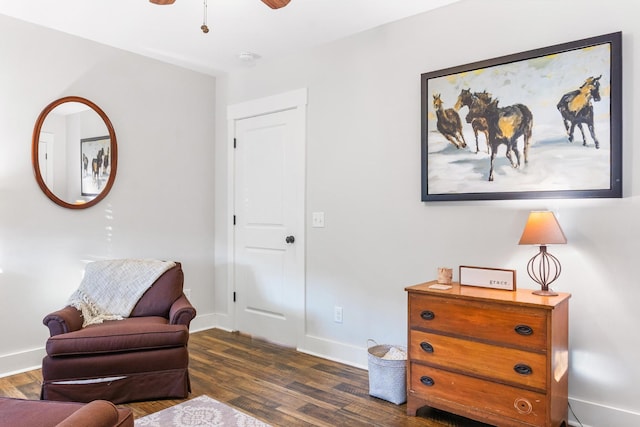 living area featuring ceiling fan and dark hardwood / wood-style floors