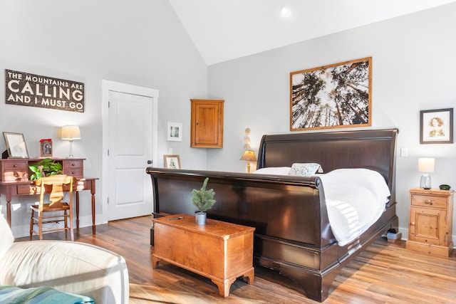 bedroom featuring light hardwood / wood-style floors and high vaulted ceiling