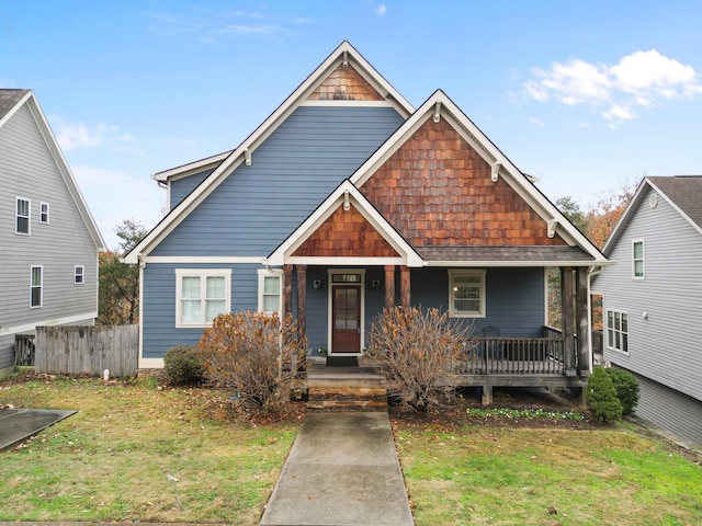 craftsman inspired home featuring a porch and a front yard