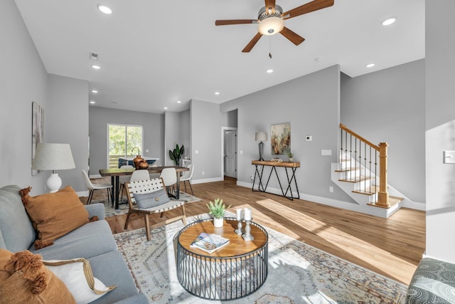 living room with ceiling fan and light hardwood / wood-style floors