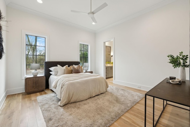 bedroom featuring ensuite bathroom, ceiling fan, crown molding, and wood-type flooring