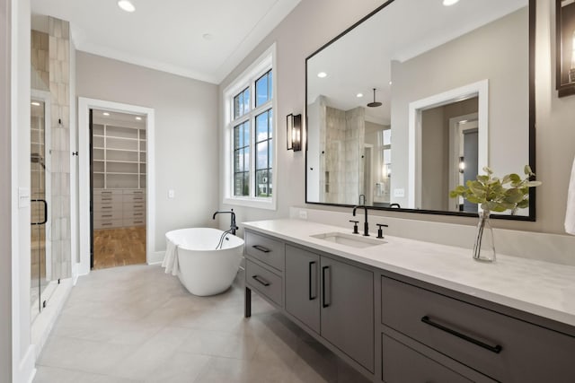 bathroom with tile patterned flooring, ornamental molding, independent shower and bath, and vanity