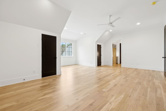 empty room featuring vaulted ceiling, light wood-type flooring, and ceiling fan