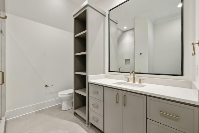 bathroom with toilet, ornamental molding, a shower with shower door, and vanity