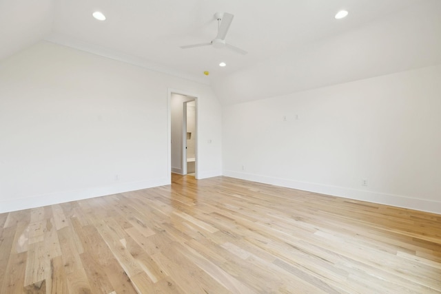 unfurnished room featuring lofted ceiling, light wood-type flooring, and ceiling fan